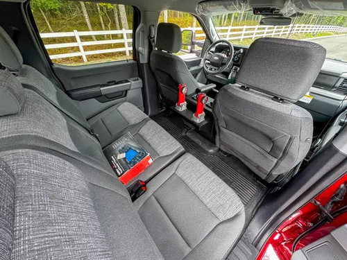 Rear cabin view showing bench seat, side trim, and floor area.